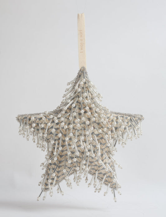Upcycled silver star Christmas ornament made from recycled sari fabric, hand embroidered with sequins, pearls, and glass beads — a fair trade, slow fashion, and zero waste clothing accessory.