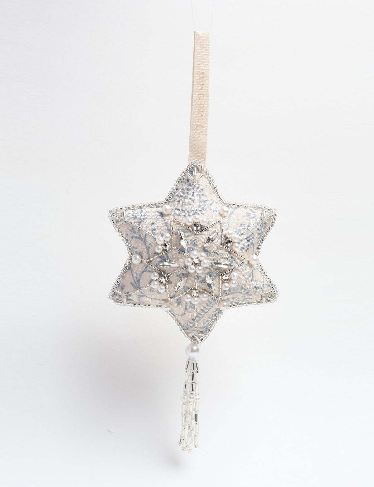 Silver fabric star ornament with blue floral pattern, pearl and crystal bead embellishments, and hanging tassel detail
