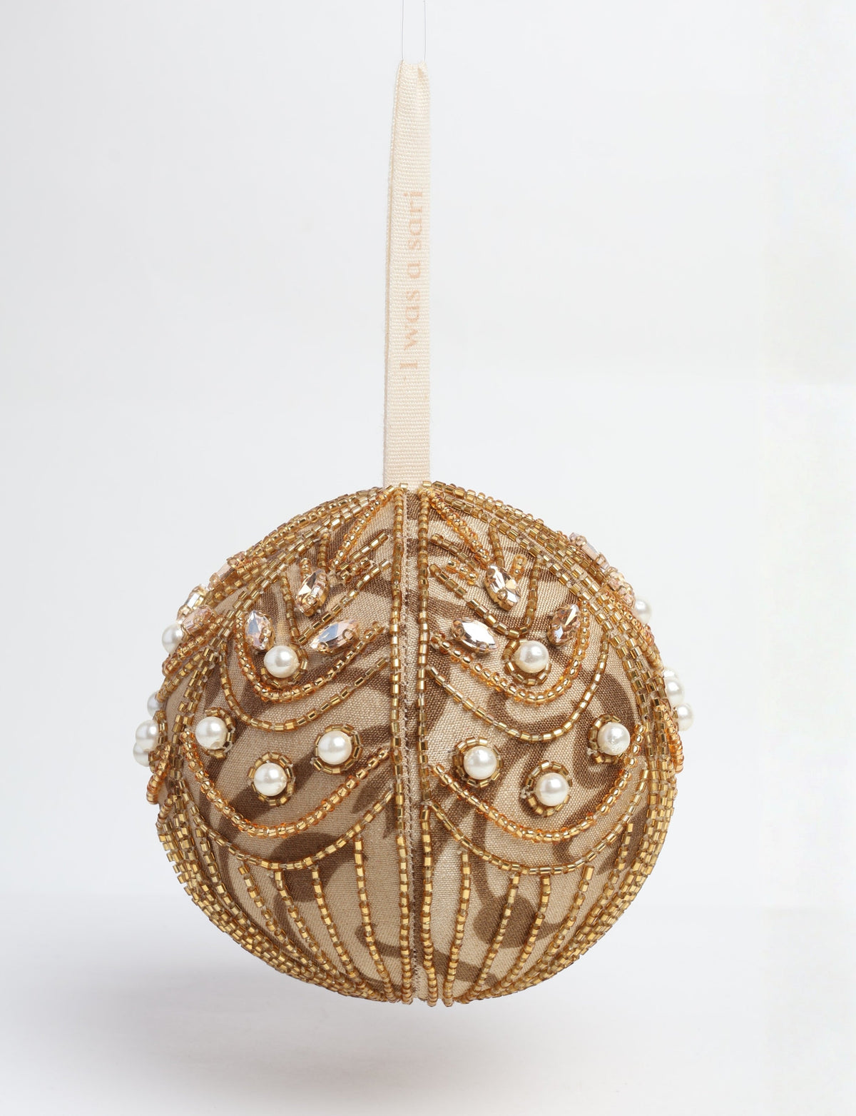 Gold fabric ball ornament decorated with gold beads, clear crystals, and white pearls, hanging by a cream ribbon with text