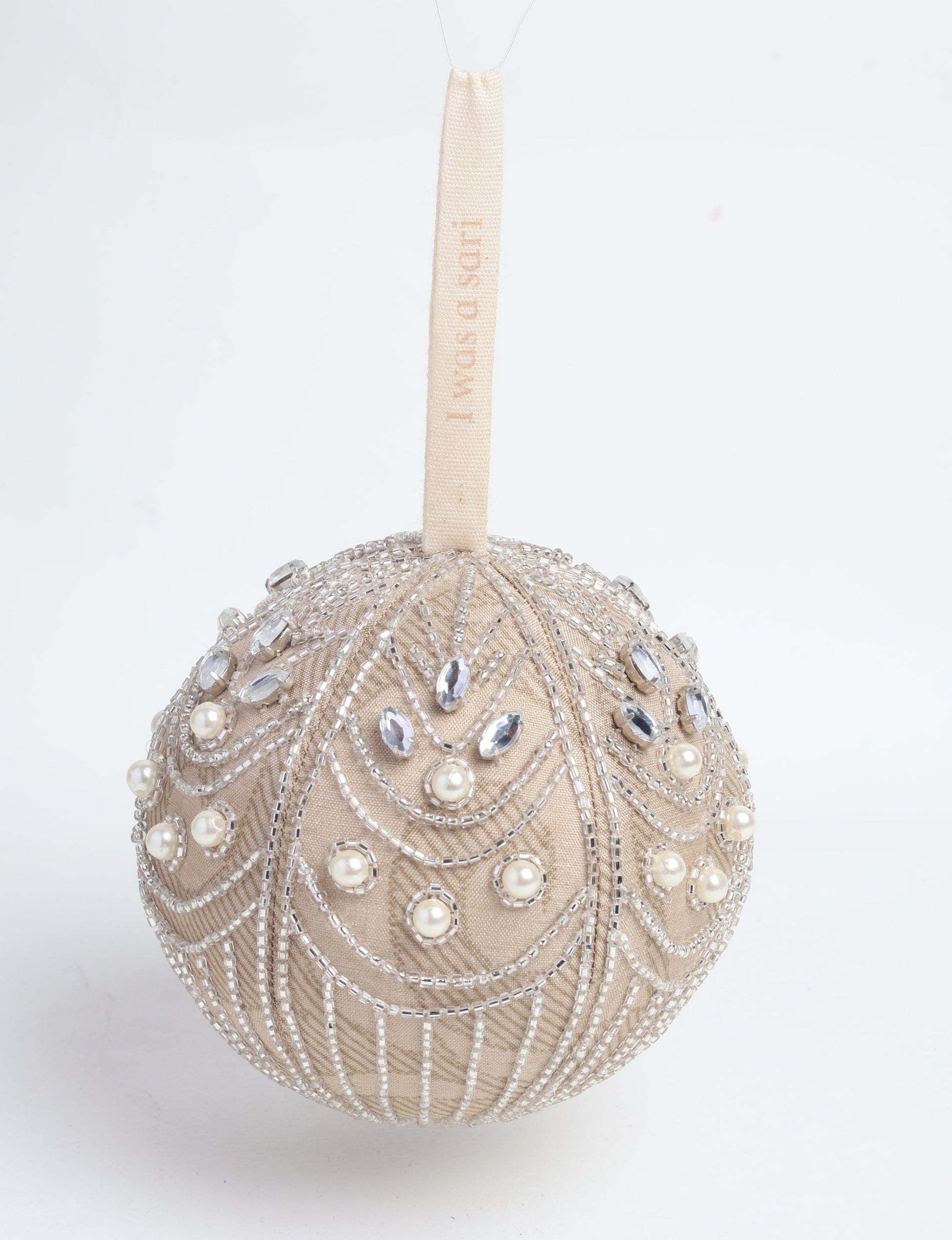 Beige ball ornament with silver beads, clear gems, and pearl accents, hanging by a cream fabric loop with text