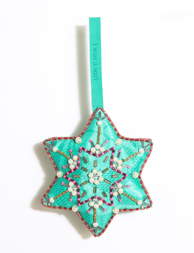 Teal fabric star-shaped snowflake ornament with bead and pearl embellishments, hanging by a teal fabric loop