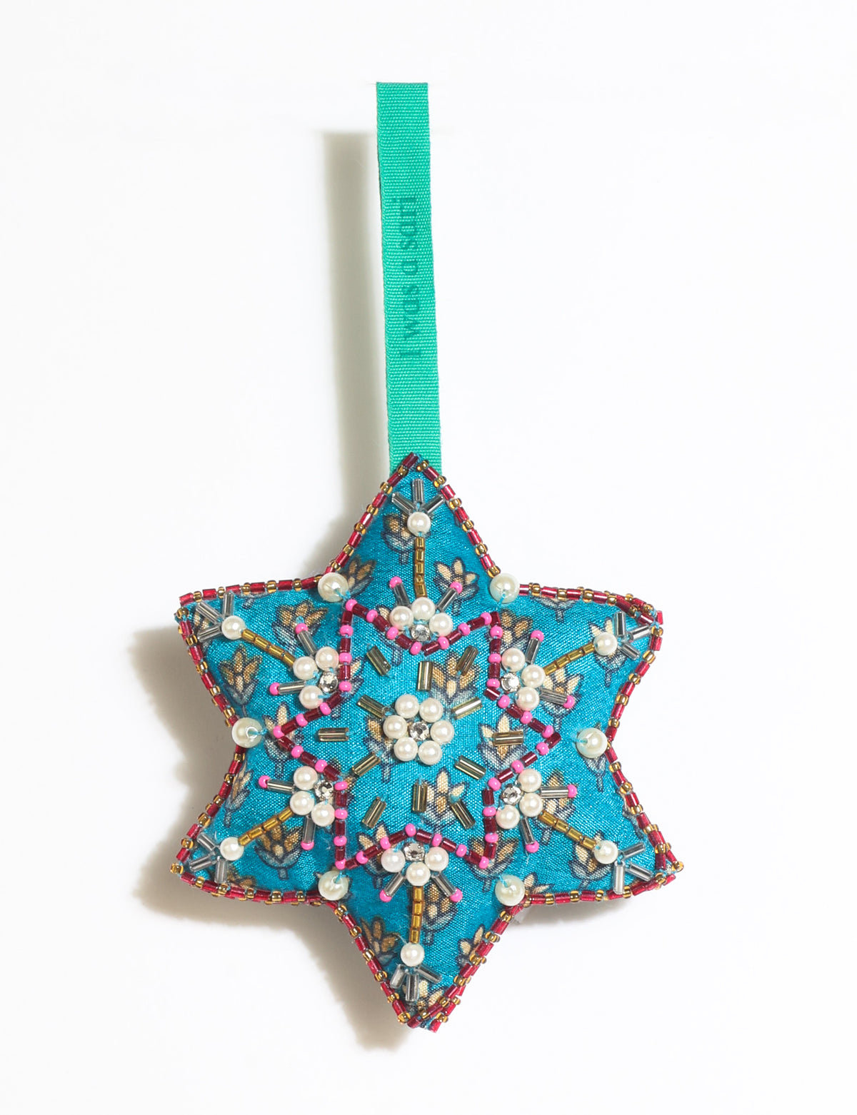 Teal fabric star-shaped snowflake ornament with bead and pearl embellishments, hanging by a teal fabric loop