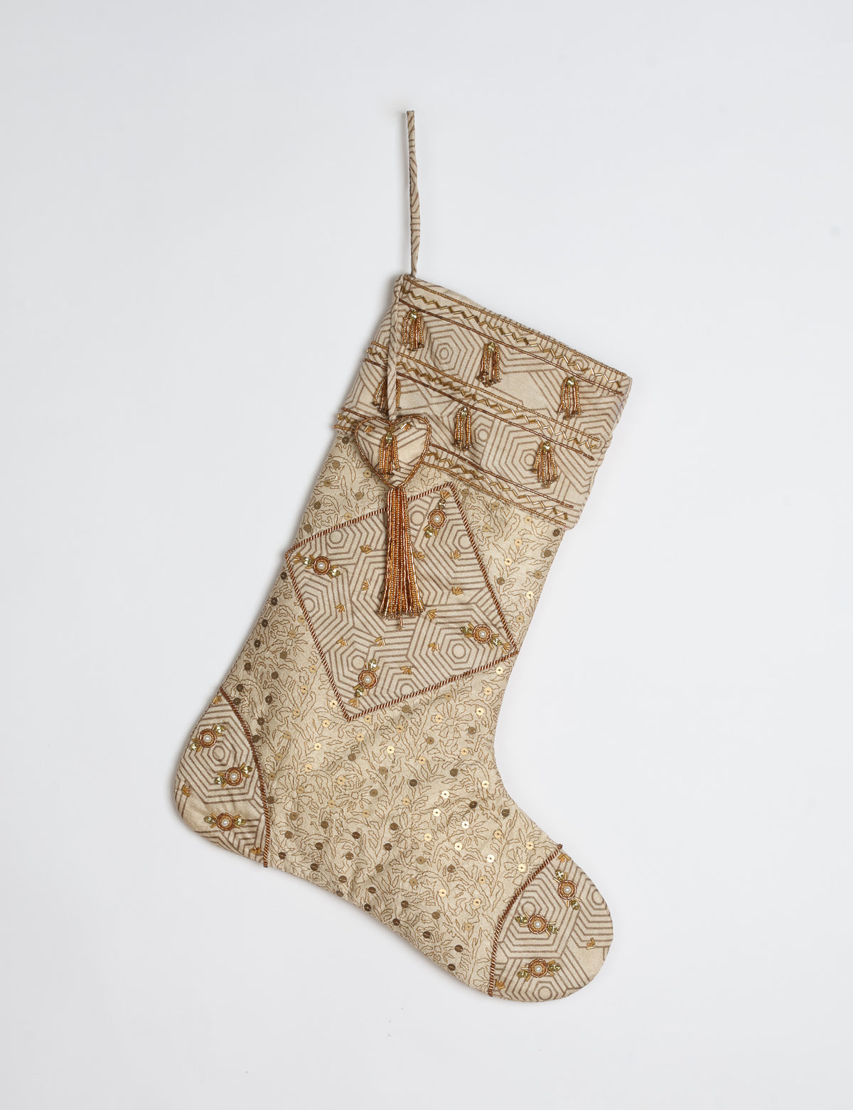 Ivory and cream upcycled sari Christmas stocking with gold hand embroidery, patchwork detailing, and a beaded heart charm tassel — crafted from recycled materials and inspired by circular, fair trade, and eco clothing fashion.