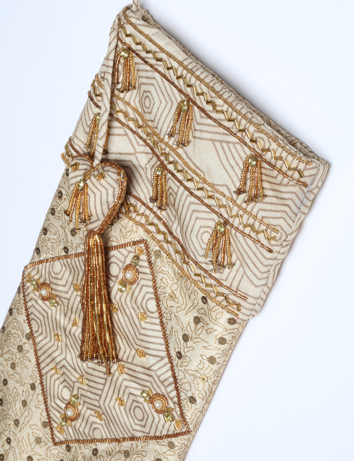 Ivory and cream upcycled sari Christmas stocking with gold hand embroidery, patchwork detailing, and a beaded heart charm tassel — crafted from recycled materials and inspired by circular, fair trade, and eco clothing fashion.