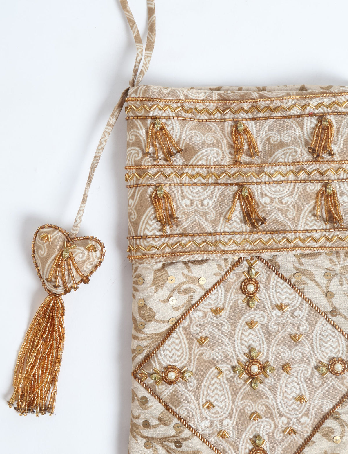 Beige patchwork Christmas stocking with leaf pattern, gold bead embellishments, sequins, and a heart-shaped tassel hanging loop