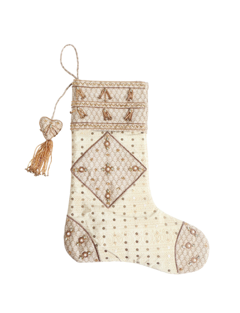 Beige patchwork Christmas stocking with paisley pattern, gold sequins, bead tassels, and heart-shaped hanging loop, front view