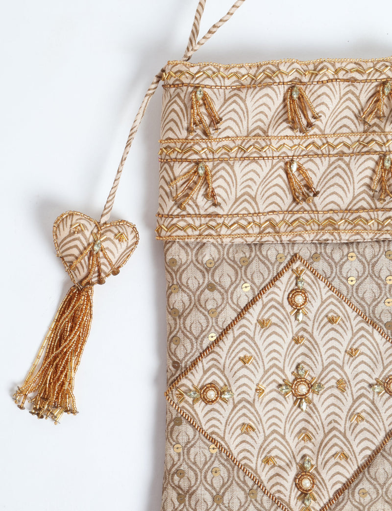 Beige patchwork Christmas stocking with micro design, gold bead embellishments, sequins, and a heart-shaped tassel hanging detail