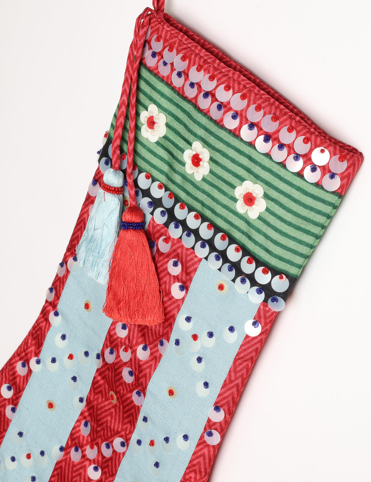 Upcycled sari Christmas stocking with striped cotton accents and hand-embroidered embellishments, reflecting green fashion, zero-waste clothing, recycled fashion, repurposed clothing, carbon-neutral fashion, natural clothing, conscious clothing, and sustainable women’s clothing.