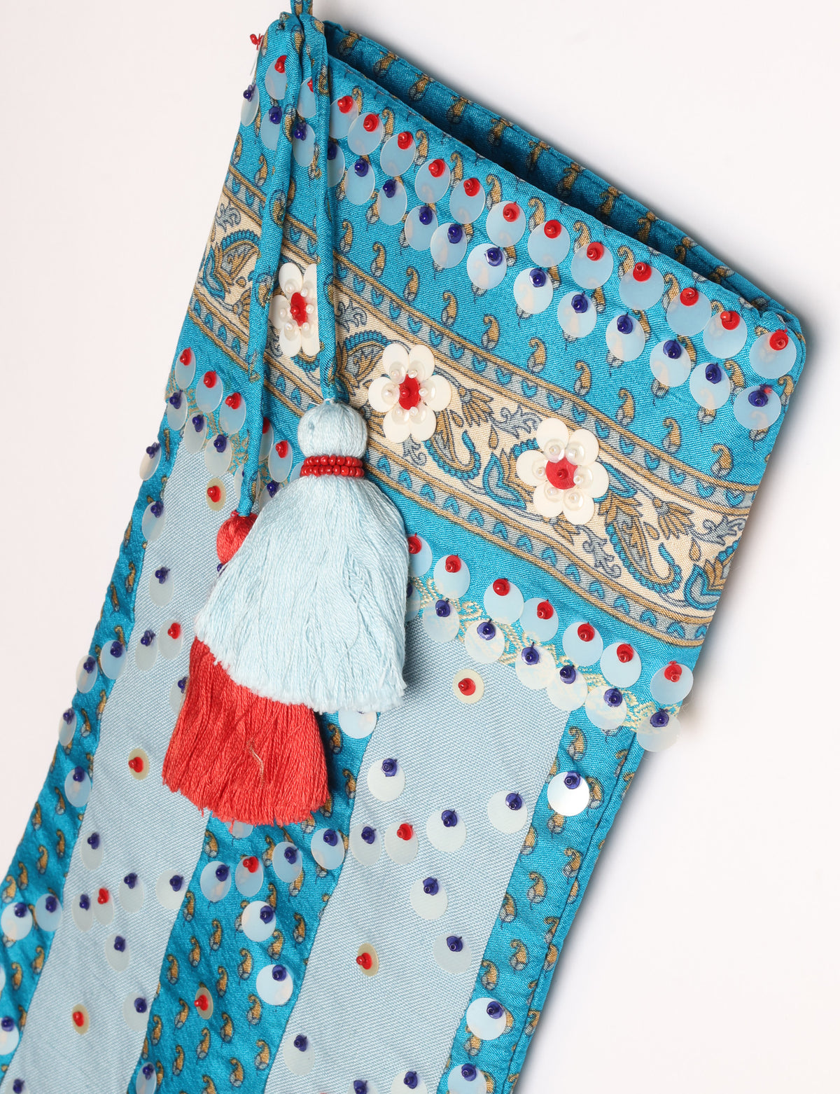 Upcycled sari Christmas stocking with striped cotton accents and hand-embroidered embellishments, reflecting green fashion, zero-waste clothing, recycled fashion, repurposed clothing, carbon-neutral fashion, natural clothing, conscious clothing, and sustainable women’s clothing.