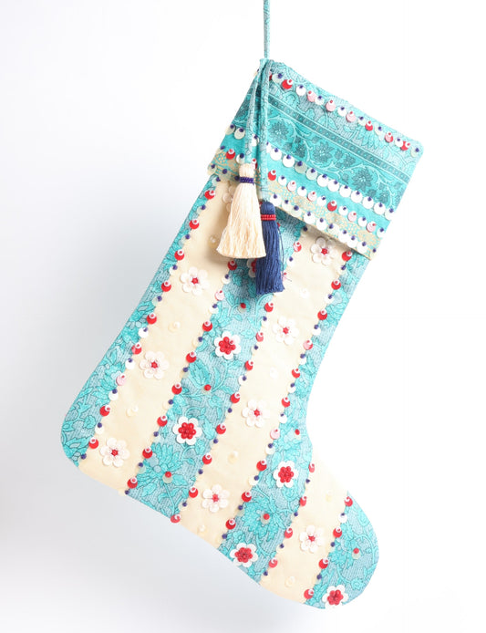 Upcycled sari Christmas stocking with floral beadwork, showcasing ethical fashion, recycled material clothing, fair trade fashion craftsmanship, and environment friendly clothing design.