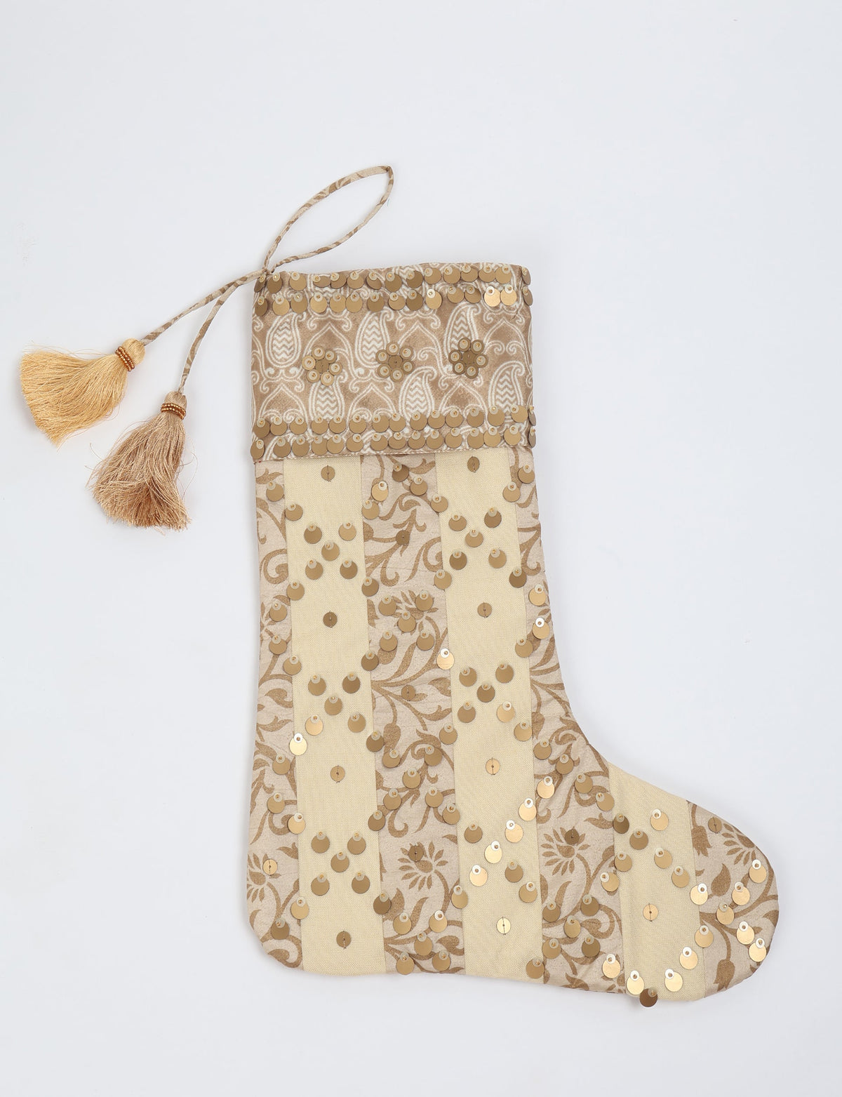 Beige and cream striped Christmas stocking with gold sequins, paisley pattern cuff, and two beige tassels on hanging loop