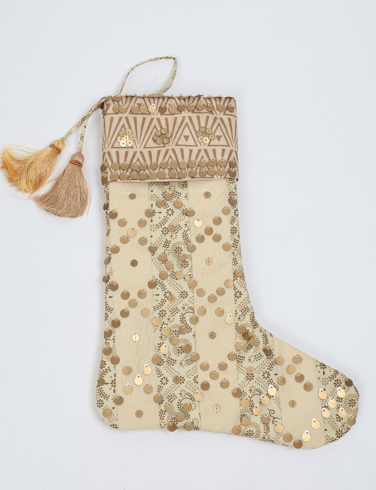 Beige Christmas stocking with vertical stripes, floral patterns, gold sequins, geometric cuff, and two tassels on hanging
