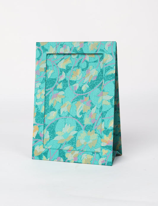 A5 rectangular fabric-covered tabletop photo frame with fold-out stand, created using upcycled clothing and repurposed clothing techniques. An eco friendly product inspired by zero waste clothing, fair trade fashion, and environmentally friendly clothing ideals, perfect for displaying photos or posters.