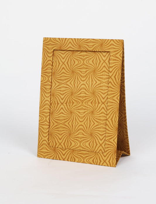 A5 rectangular fabric-covered tabletop photo frame with fold-out stand, created using upcycled clothing and repurposed clothing techniques. An eco friendly product inspired by zero waste clothing, fair trade fashion, and environmentally friendly clothing ideals, perfect for displaying photos or posters.