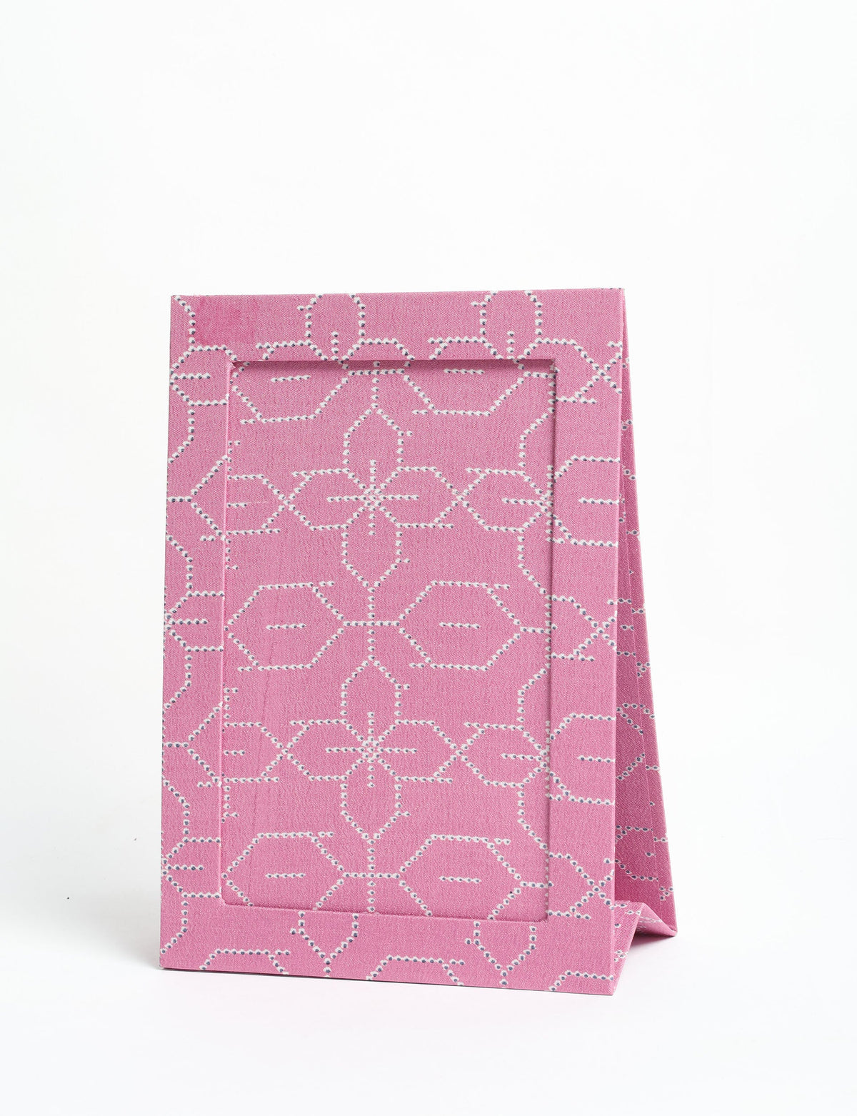 Pink geometric patterned fabric photo frame standing upright with an A5 size display window on a white background