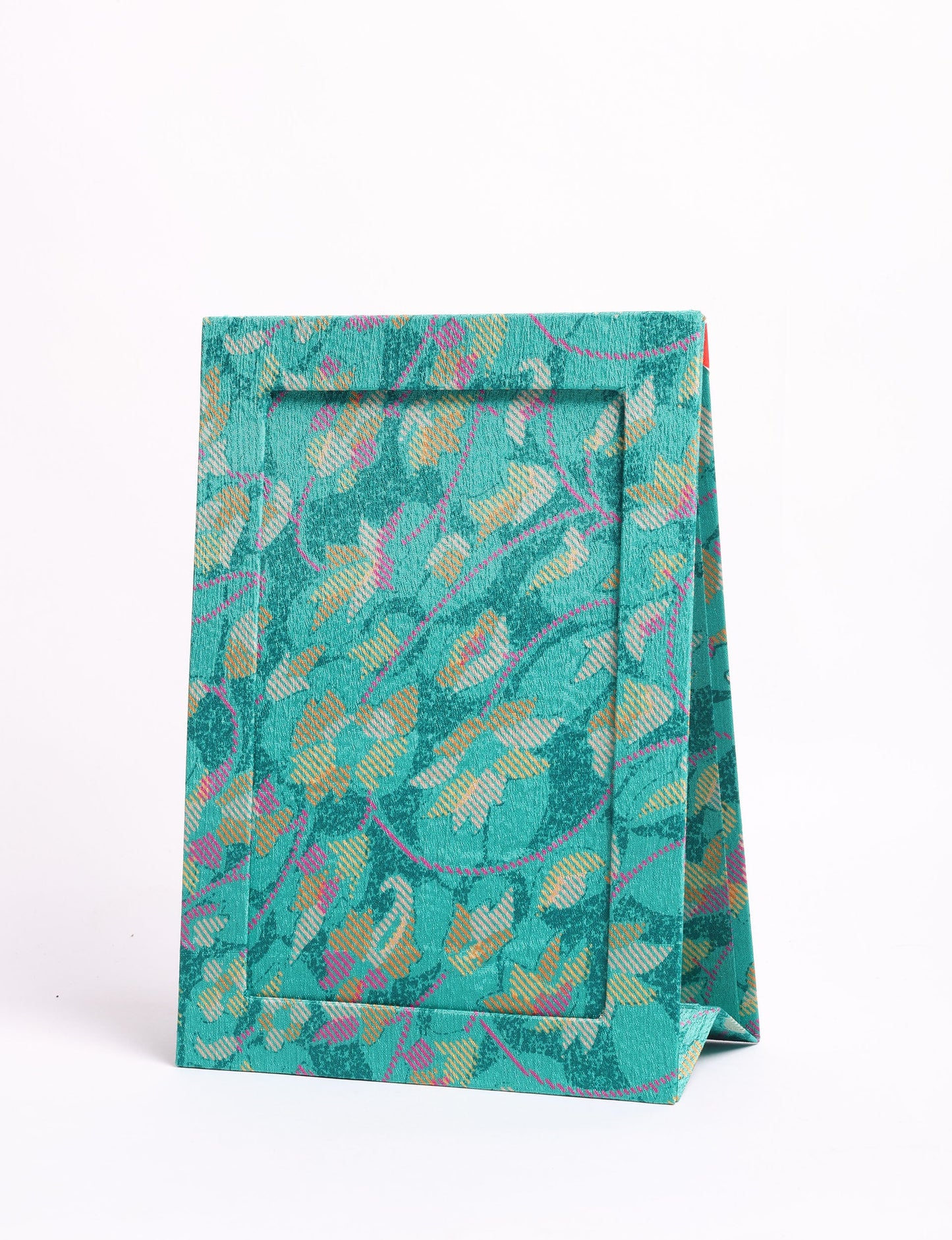 A5 rectangular fabric-covered tabletop photo frame with fold-out stand, created using upcycled clothing and repurposed clothing techniques. An eco friendly product inspired by zero waste clothing, fair trade fashion, and environmentally friendly clothing ideals, perfect for displaying photos or posters.