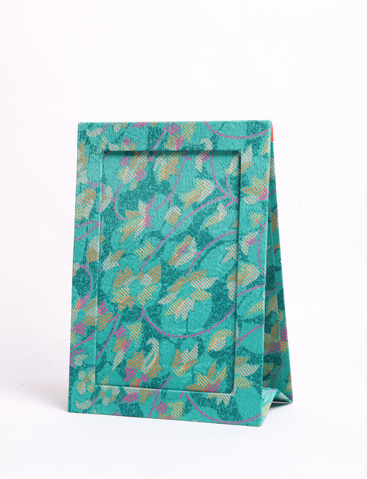 A5 rectangular fabric-covered tabletop photo frame with fold-out stand, created using upcycled clothing and repurposed clothing techniques. An eco friendly product inspired by zero waste clothing, fair trade fashion, and environmentally friendly clothing ideals, perfect for displaying photos or posters.