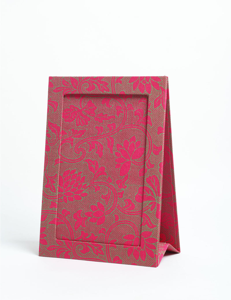 Pink tropical patterned fabric photo frame in A5 size, standing upright on a white background