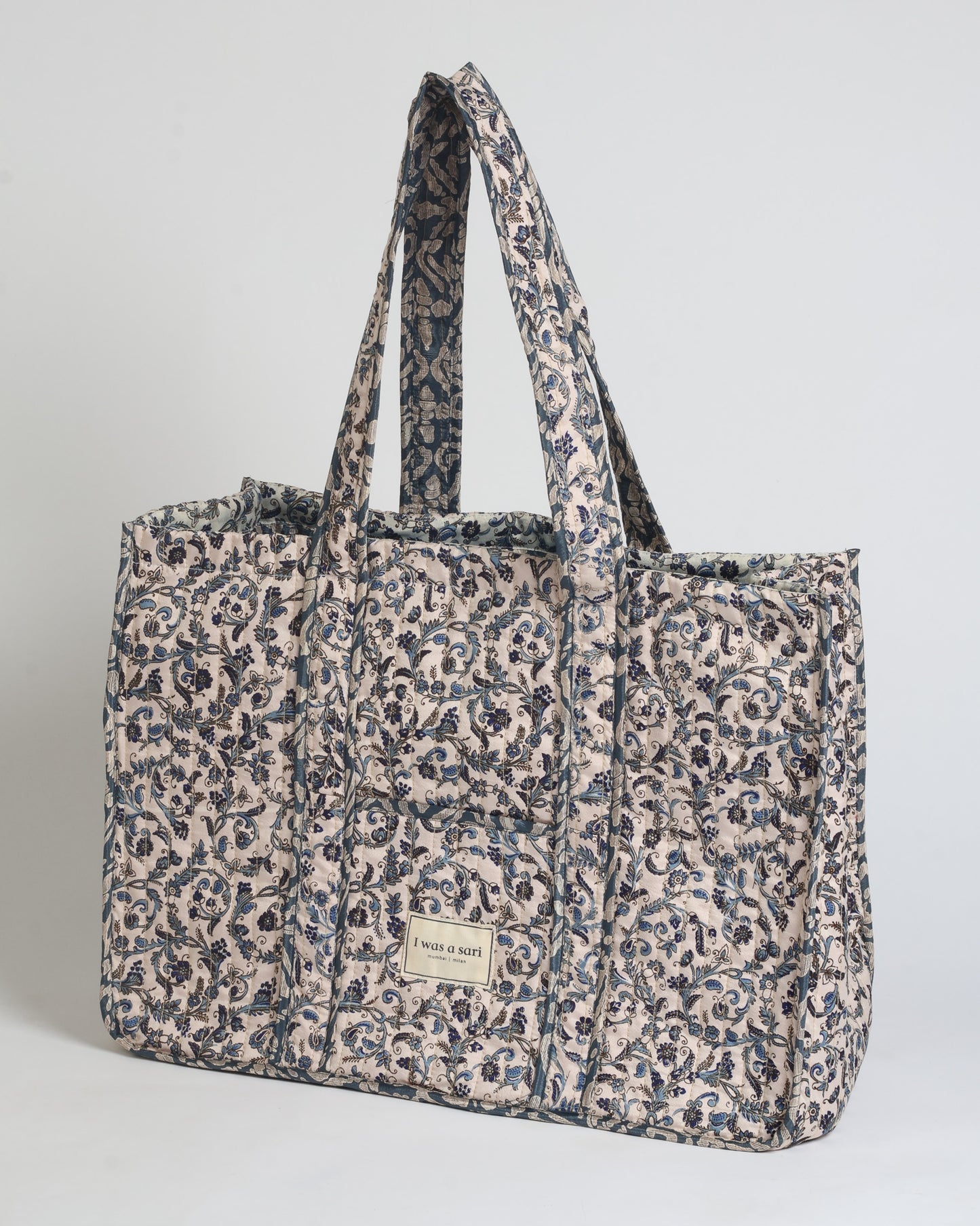 Quilted work tote bag with structured rectangular design and long shoulder straps, representing slow fashion and ethical clothing ideals, made as part of upcycled women's clothing and sustainable women's clothing using recycled fashion and earth friendly clothing practices.