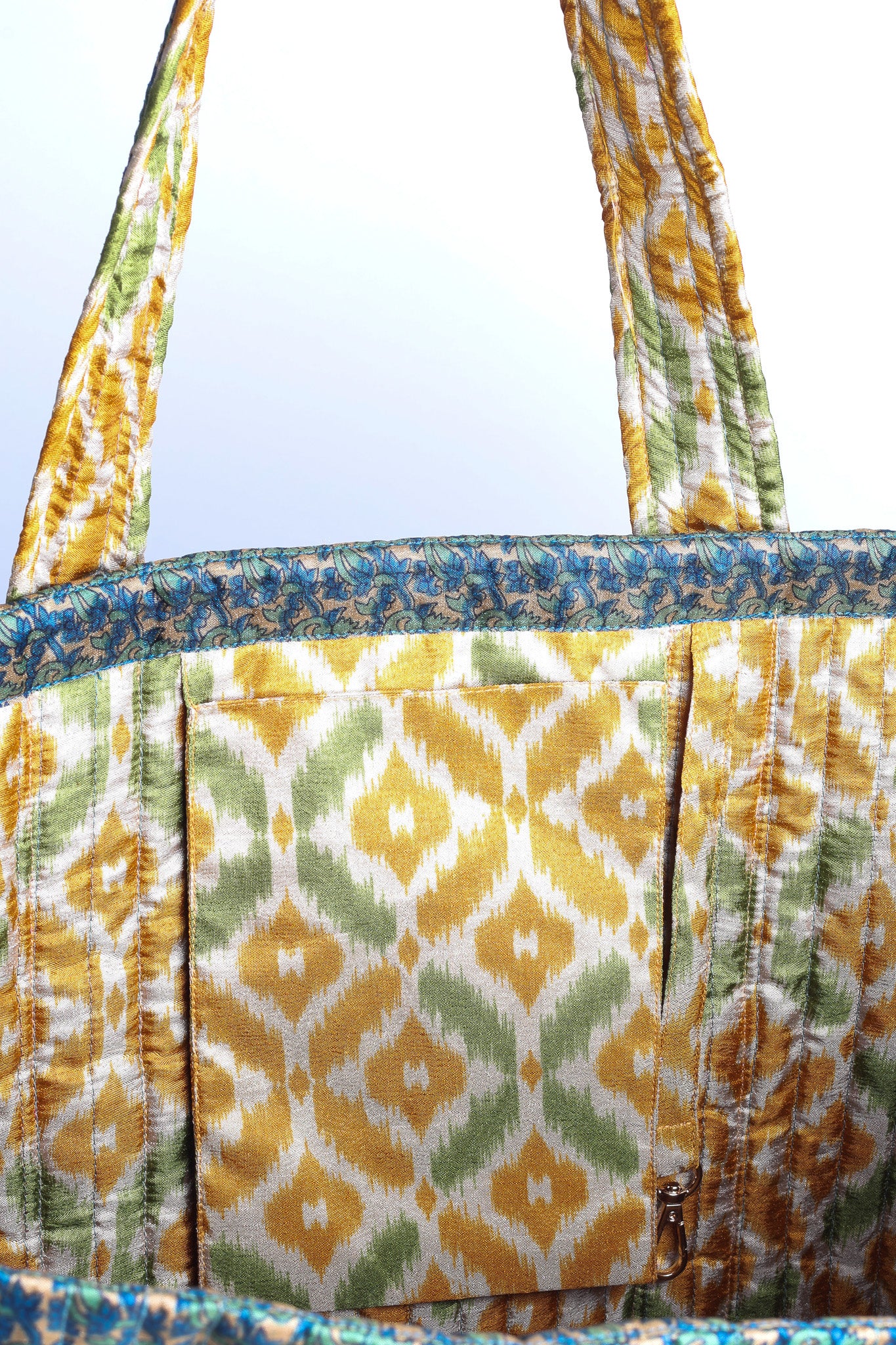 Quilted work tote bag with structured rectangular design and long shoulder straps, representing slow fashion and ethical clothing ideals, made as part of upcycled women's clothing and sustainable women's clothing using recycled fashion and earth friendly clothing practices.