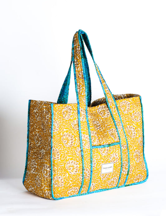 Quilted work tote bag with structured rectangular design and long shoulder straps, representing slow fashion and ethical clothing ideals, made as part of upcycled women's clothing and sustainable women's clothing using recycled fashion and earth friendly clothing practices.