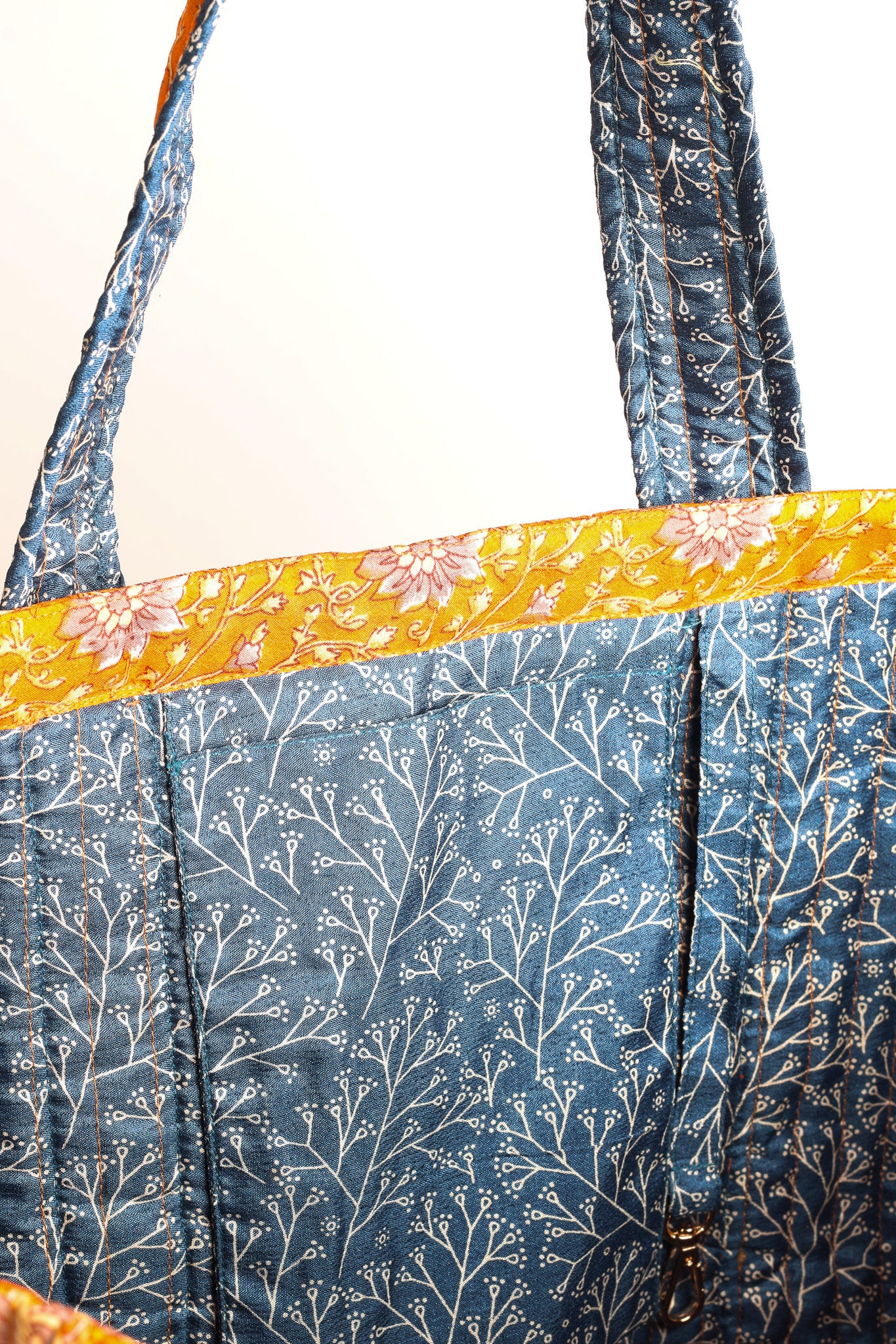 Quilted work tote bag with structured rectangular design and long shoulder straps, representing slow fashion and ethical clothing ideals, made as part of upcycled women's clothing and sustainable women's clothing using recycled fashion and earth friendly clothing practices.