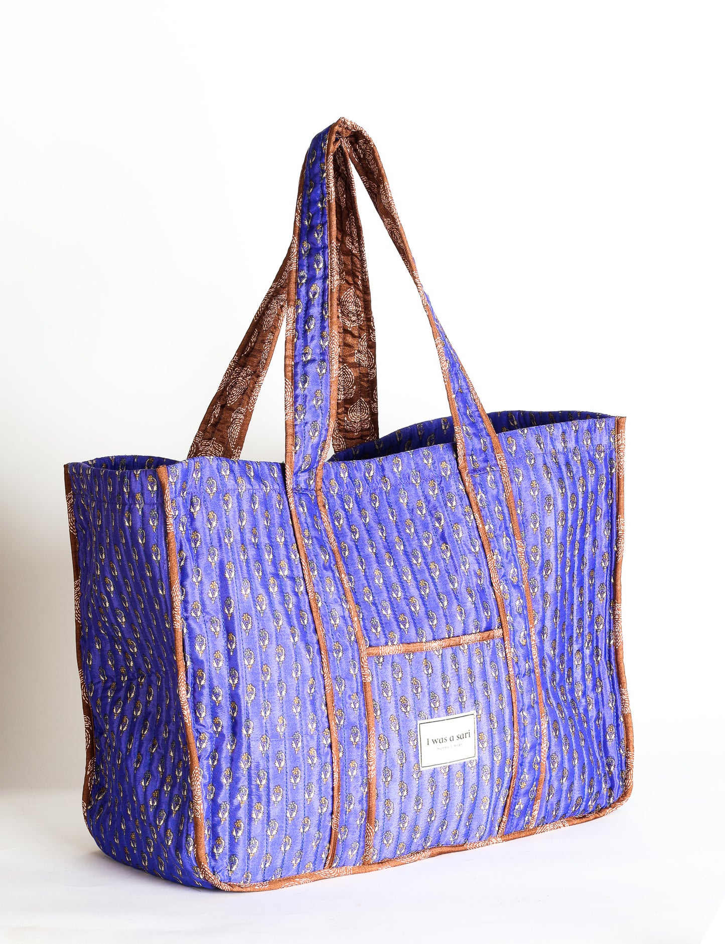Quilted work tote bag with structured rectangular design and long shoulder straps, representing slow fashion and ethical clothing ideals, made as part of upcycled women's clothing and sustainable women's clothing using recycled fashion and earth friendly clothing practices.