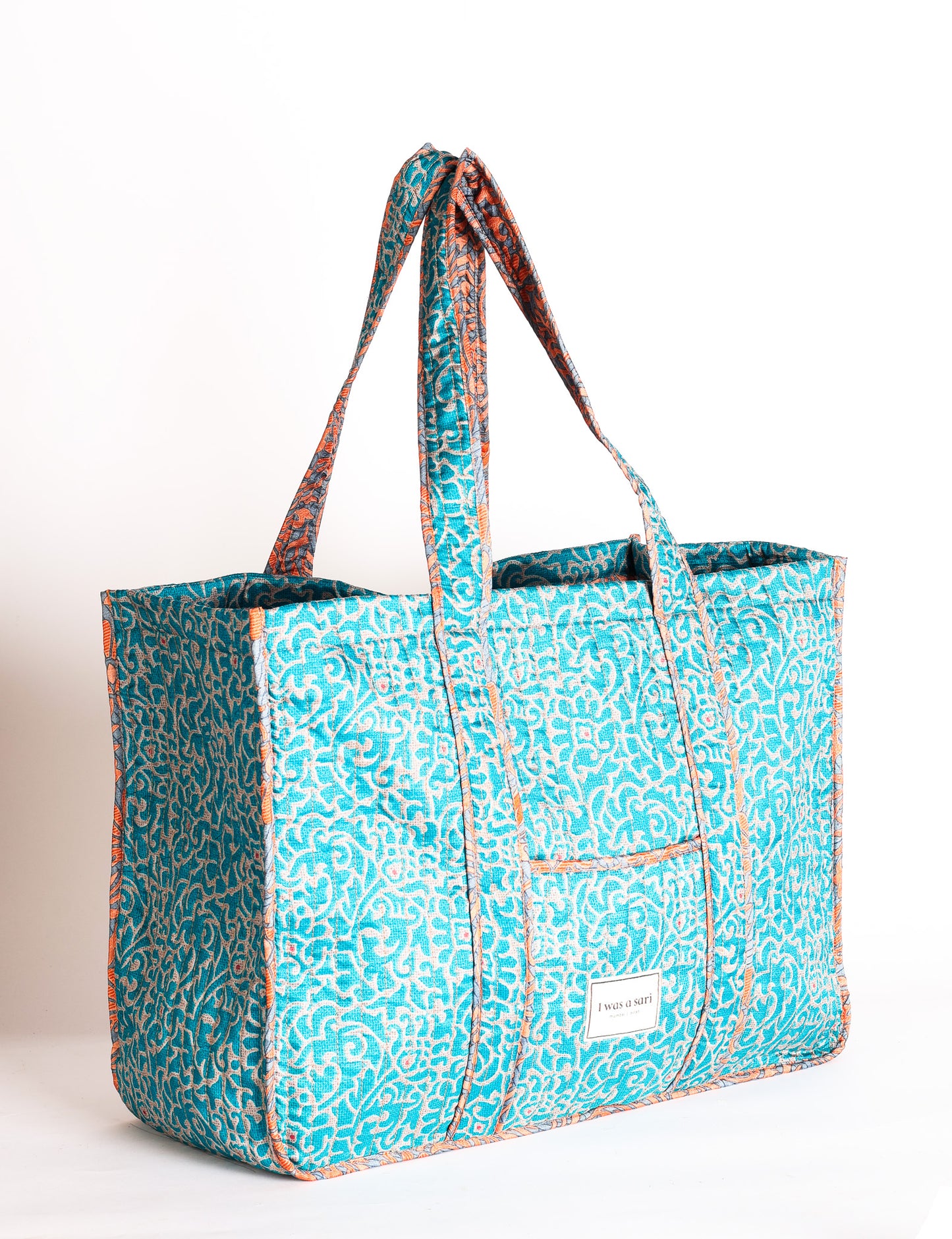 Quilted work tote bag with structured rectangular design and long shoulder straps, representing slow fashion and ethical clothing ideals, made as part of upcycled women's clothing and sustainable women's clothing using recycled fashion and earth friendly clothing practices.