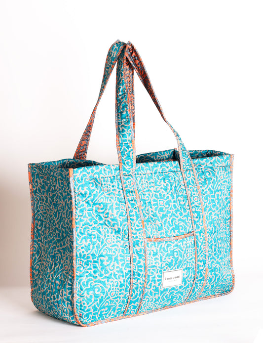Quilted work tote bag with structured rectangular design and long shoulder straps, representing slow fashion and ethical clothing ideals, made as part of upcycled women's clothing and sustainable women's clothing using recycled fashion and earth friendly clothing practices.