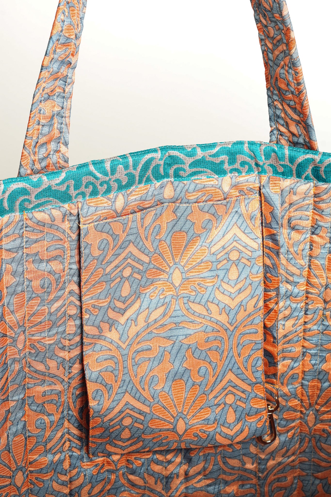 Quilted work tote bag with structured rectangular design and long shoulder straps, representing slow fashion and ethical clothing ideals, made as part of upcycled women's clothing and sustainable women's clothing using recycled fashion and earth friendly clothing practices.