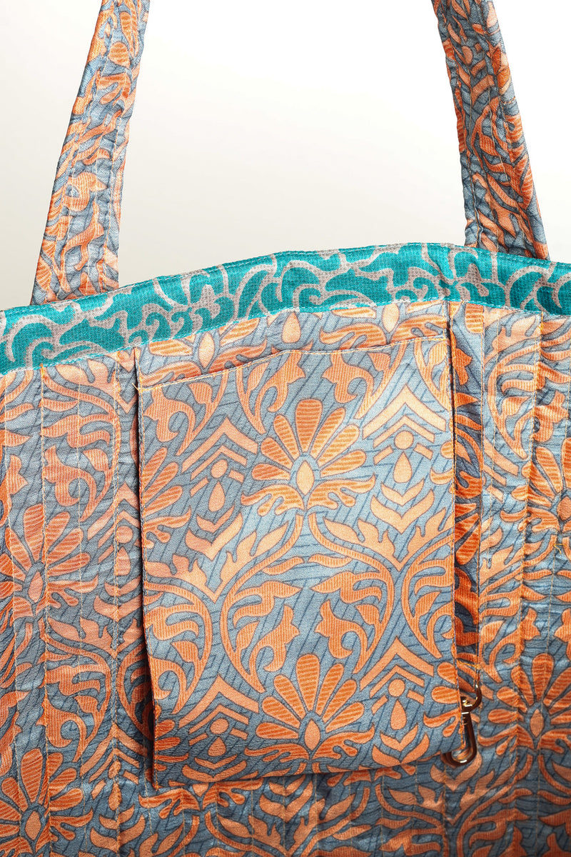 Quilted work tote bag with structured rectangular design and long shoulder straps, representing slow fashion and ethical clothing ideals, made as part of upcycled women's clothing and sustainable women's clothing using recycled fashion and earth friendly clothing practices.