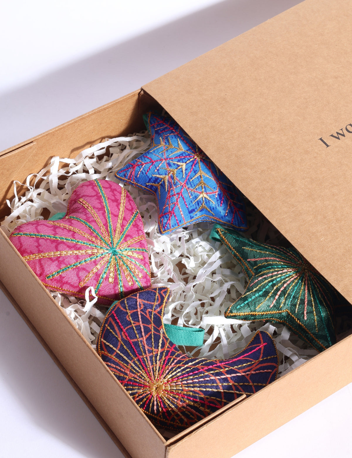 Handcrafted Christmas ornament gift box set with four upcycled sari ornaments in heart, star, snowflake and crescent moon shapes, embroidered with silk and gold threads.