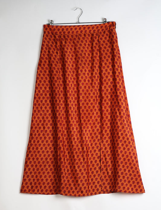 Midi A-line skirt with front slit, fitted waistband, concealed side closure, and below mid-calf length silhouette.