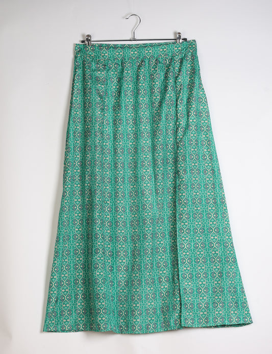 Midi A-line skirt with front slit, fitted waistband, concealed side closure, and below mid-calf length silhouette.