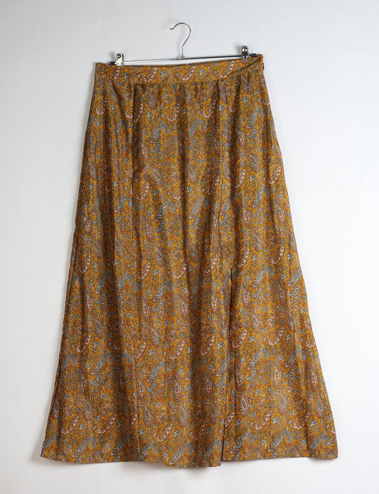 Midi A-line skirt with front slit, fitted waistband, concealed side closure, and below mid-calf length silhouette.