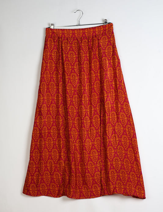 Midi A-line skirt with front slit, fitted waistband, concealed side closure, and below mid-calf length silhouette.