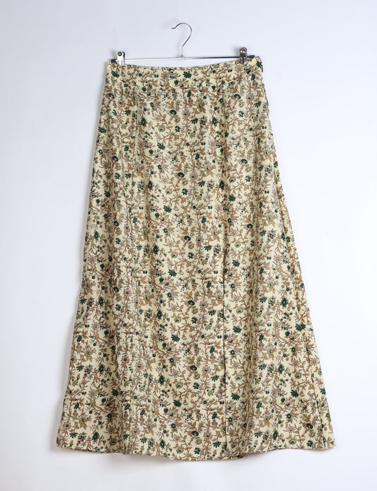 Midi A-line skirt with front slit, fitted waistband, concealed side closure, and below mid-calf length silhouette.