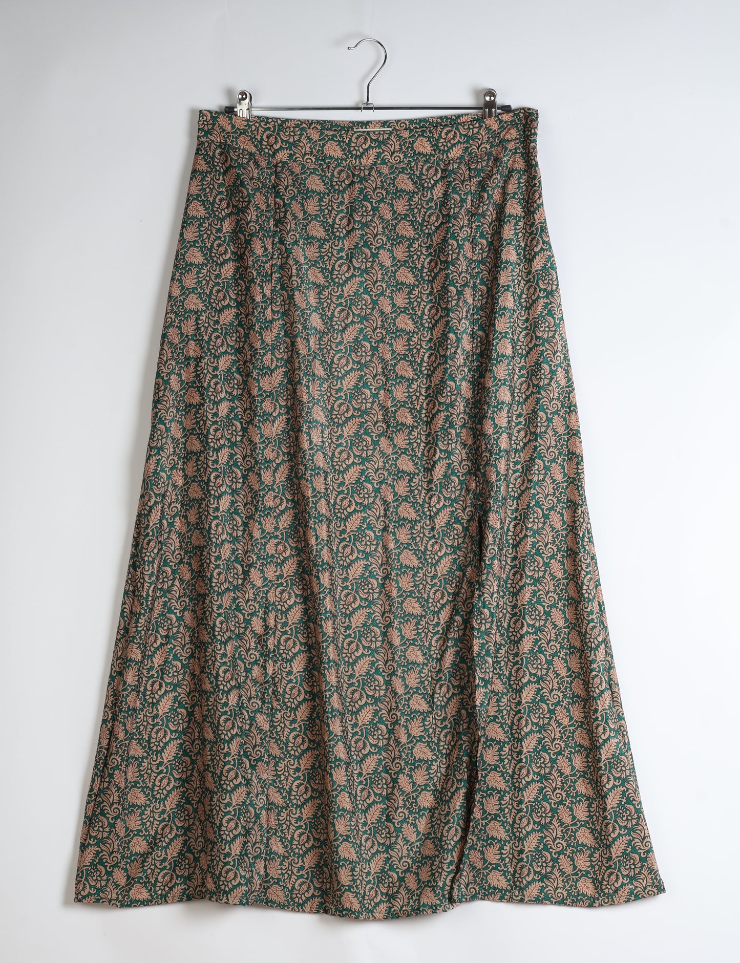 Midi A-line skirt with front slit, fitted waistband, concealed side closure, and below mid-calf length silhouette.