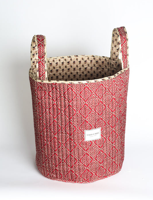 Quilted storage basket with handle in a soft cylindrical design, available in small and medium sizes for home organization.
