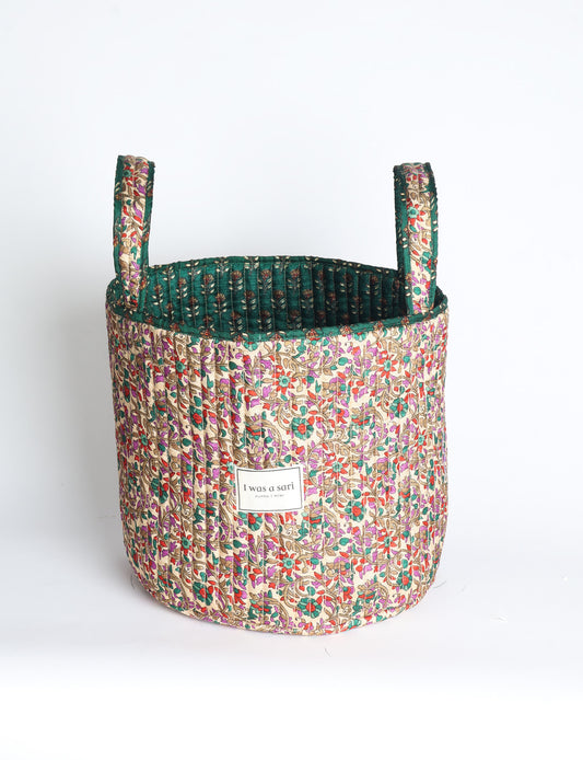 Quilted storage basket with handle in a soft cylindrical design, available in small and medium sizes for home organization.