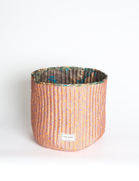 Quilted storage basket in a soft cylindrical shape, available in S, M, L, and XL sizes