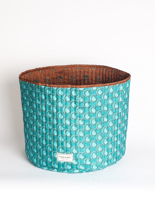 Quilted storage basket in a soft cylindrical shape, available in S, M, L, and XL sizes
