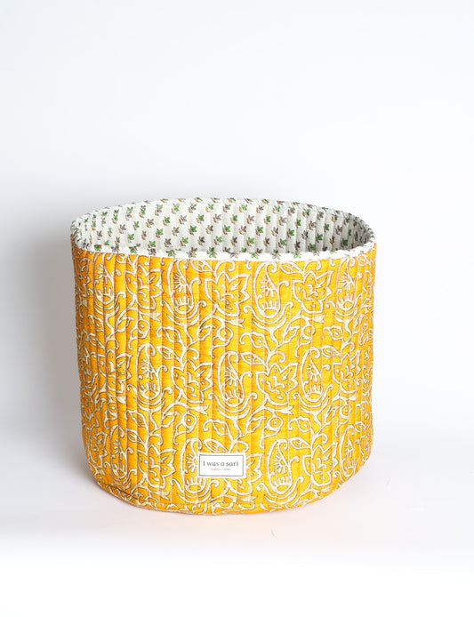 Quilted storage basket in a soft cylindrical shape, available in S, M, L, and XL sizes