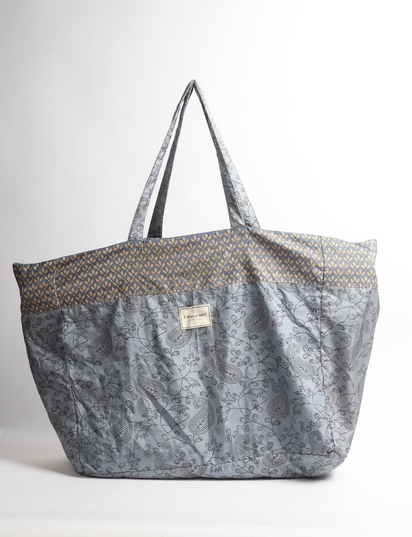 Large beach bag with a spacious rectangular design, wide top opening, and comfortable shoulder handles for carrying daily and travel essentials.