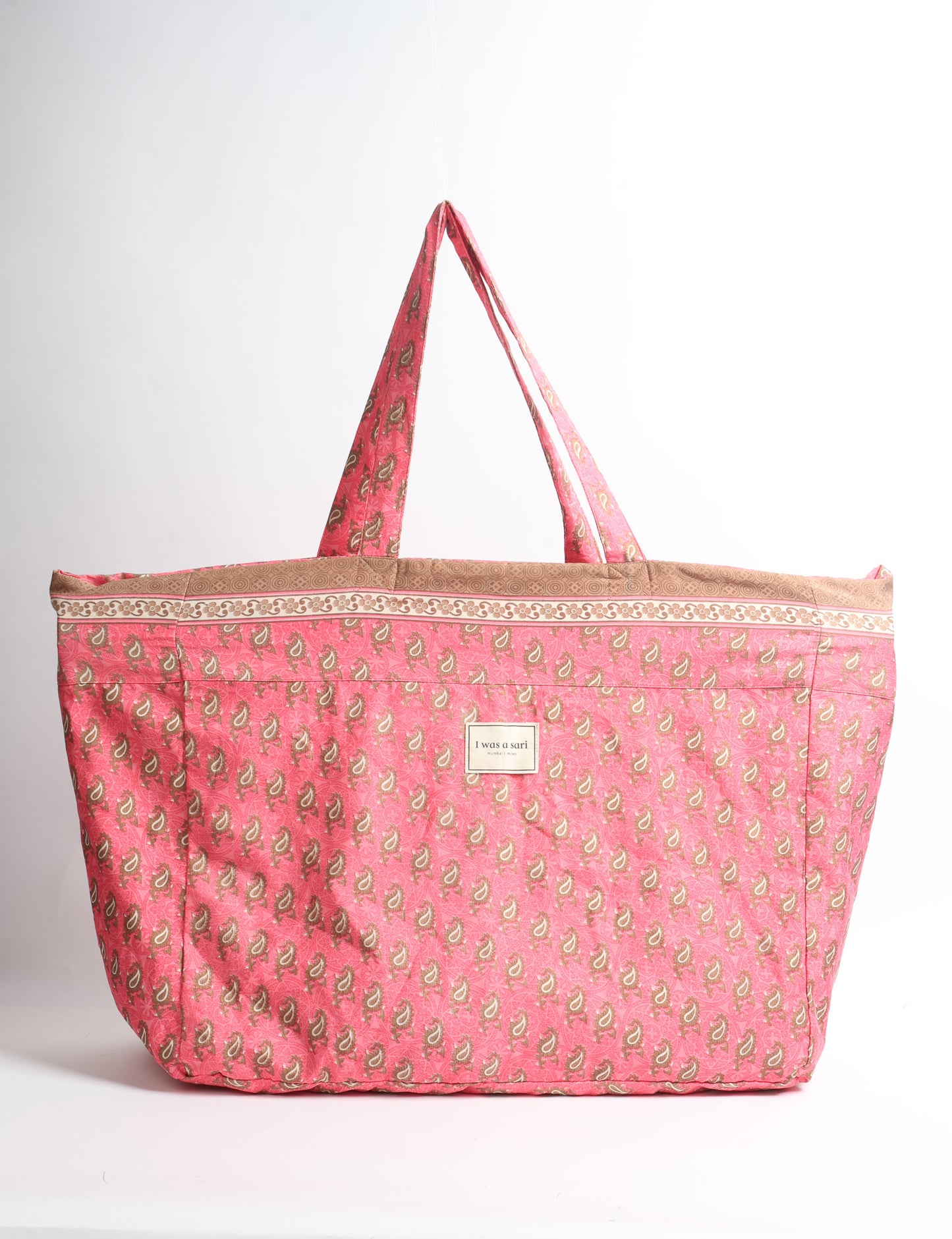 Large beach bag with a spacious rectangular design, wide top opening, and comfortable shoulder handles for carrying daily and travel essentials.