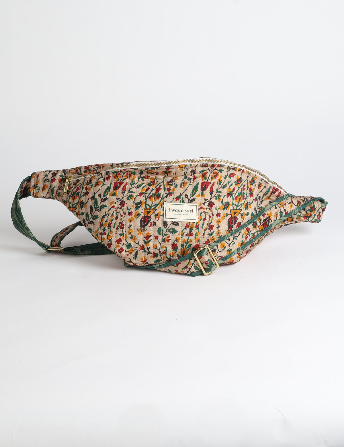 Quilted large shoulder bag with a curved silhouette, adjustable strap and zip-top closure.