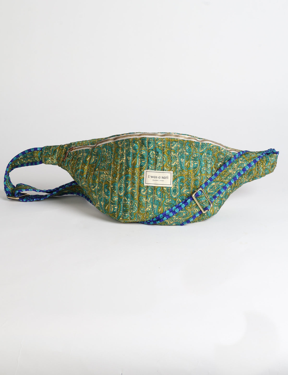 Quilted large shoulder bag with a curved silhouette, adjustable strap and zip-top closure.