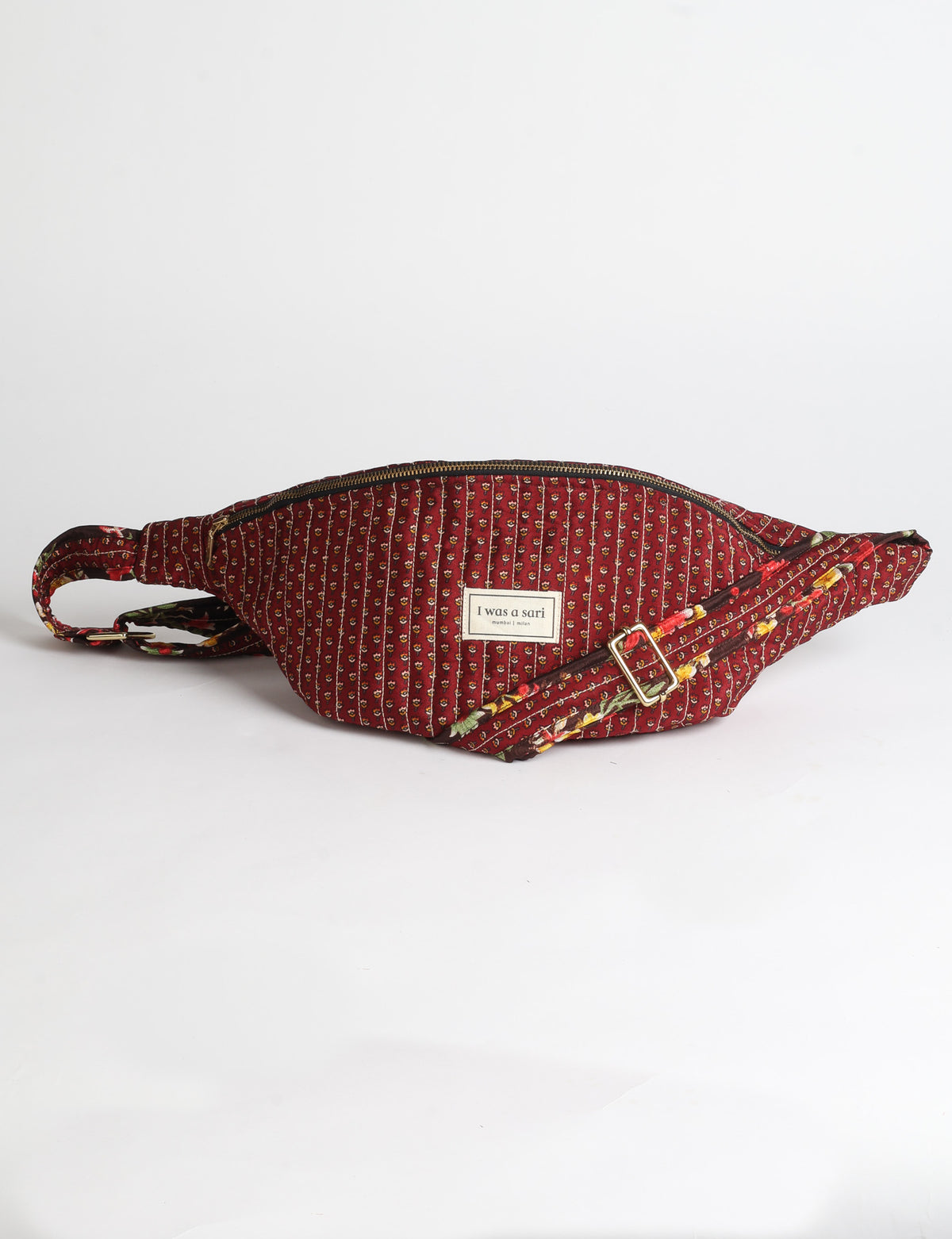 Quilted large shoulder bag with a curved silhouette, adjustable strap and zip-top closure.