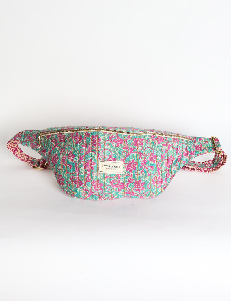 Quilted large shoulder bag featuring a curved silhouette, spacious structured compartment, adjustable strap and secure zip-top closure. A versatile everyday bag designed for shoulder or crossbody wear.v