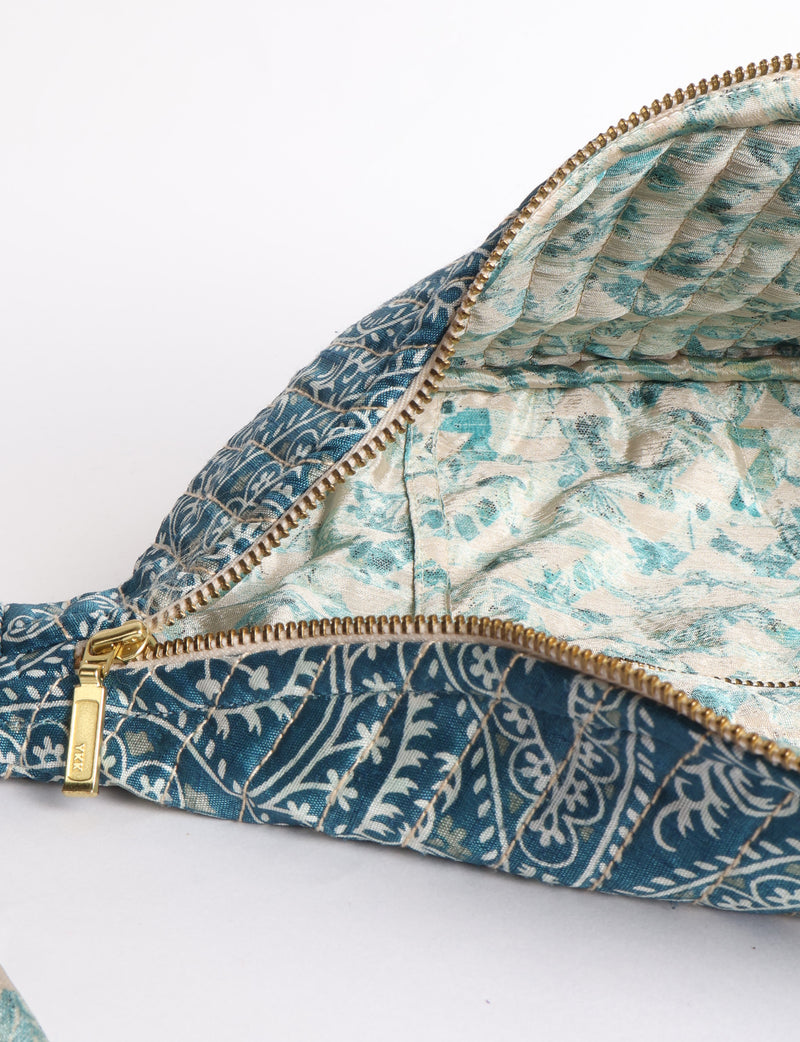 Quilted large shoulder bag featuring a curved silhouette, spacious structured compartment, adjustable strap and secure zip-top closure. A versatile everyday bag designed for shoulder or crossbody wear.v